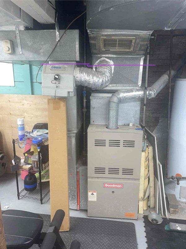 Conducted on-site assessment for heat pump addition to existing natural gas furnace system in basement location. Current Goodman furnace unit, over 10 years old and operational, evaluated for integration with proposed heat pump system for dual heating and cooling capability. Documented existing HVAC configuration including ductwork layout, electrical connections, and available space for new equipment installation.