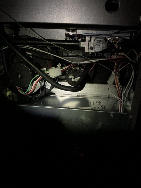 Completed comprehensive Gold AC inspection on a 1-year-old residential air conditioning system with air handler located in basement. Performed thorough visual inspection of indoor air handler components including blower motor assembly, electrical connections, wire harnesses, control modules, and refrigerant lines. Inspected outdoor condensing unit including fan assembly with radial blade configuration, verified proper operation of all mechanical components, and confirmed unit exterior condition. System found to be operating properly with all components functioning as designed and no service issues identified.