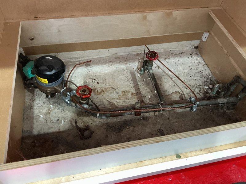 Responded to service call for meter valve and hose bib inspection. Upon arrival, accessed mechanical compartment housing compressor system with copper piping network and identified worn valve components requiring attention. Removed and inspected defective valve assembly, which showed significant wear and age-related deterioration. Replaced faulty valve component to restore proper function and prevent potential water leakage. Tested system operation to verify repair integrity and proper valve operation. All components functioning correctly upon completion.