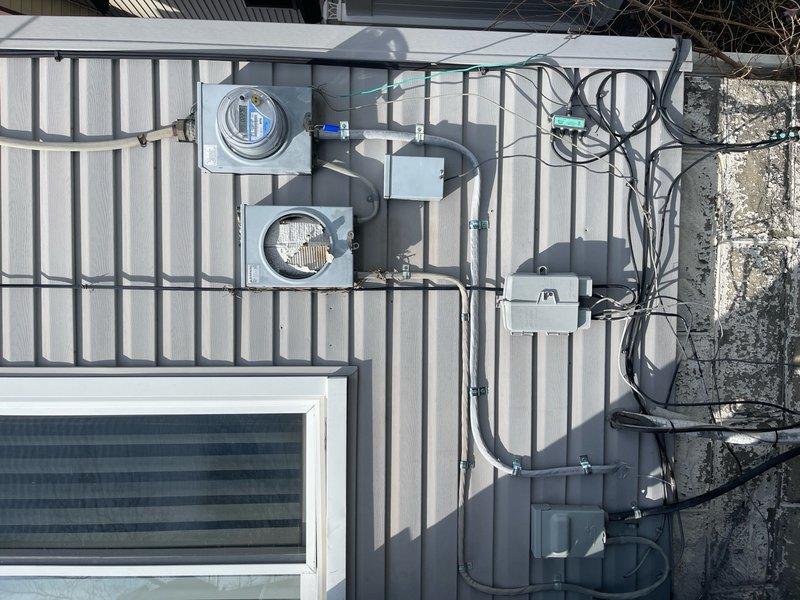 Replaced deteriorated lower service cable feeding main electrical panel. Removed old service entrance conductors and installed new appropriately-sized cable from meter base to main distribution panel. Verified proper torque connections at all termination points and confirmed correct polarity. Tested electrical loads with clamp meter to ensure balanced distribution across phases and verified system integrity upon restoration of power.