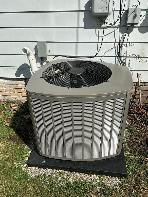 Completed system start-up and commissioning of newly installed Lennox air conditioning system. Verified outdoor condenser unit is properly positioned on pad with adequate clearance, confirmed all electrical connections are secure and properly terminated at junction boxes, and tested condensate drain line for proper operation. Programmed and configured Lennox digital thermostat, verified system communication between indoor and outdoor units, and confirmed heating and cooling setpoints are functioning correctly with proper temperature readings and humidity display at 53%.