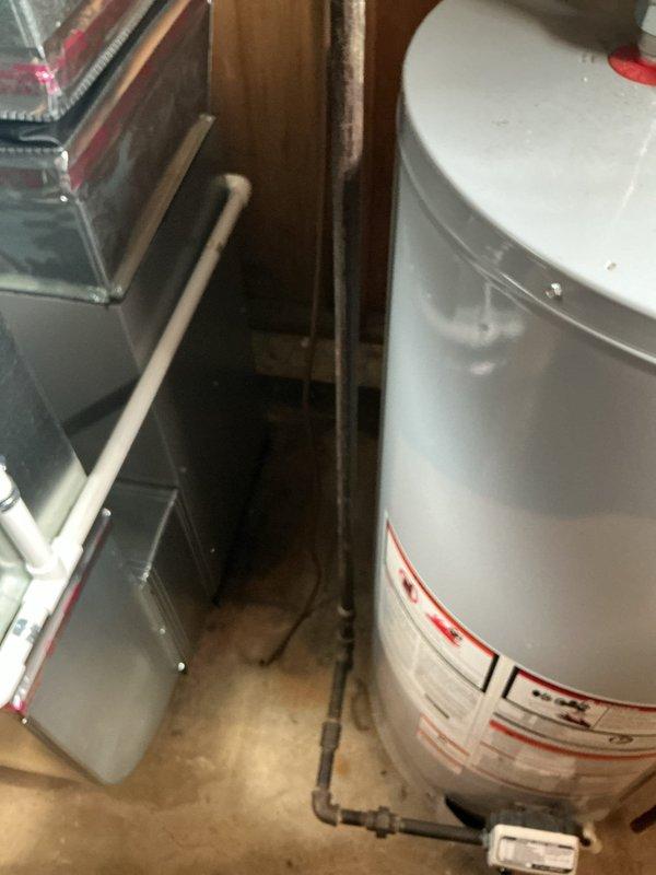 Responded to service call regarding damaged gas line to dryer allegedly caused by previous installation work. Upon inspection of mechanical room and utility space, documented existing gas piping configuration, water heater installation, HVAC equipment placement, and associated utility connections. Photographed current conditions showing vertical gas piping runs, PVC plumbing lines, and flexible ductwork in confined utility area to establish baseline assessment of reported issue.