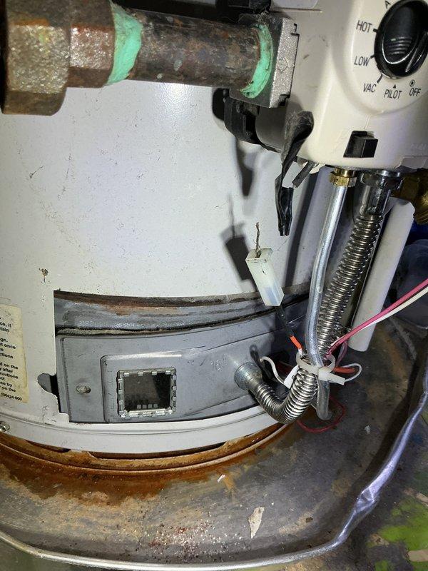 Responded to no water complaint at residential property. Upon inspection, found aging gas-fired water heater on main floor, estimated to be approximately 10 years old. Observed significant corrosion on copper supply piping with deteriorated foam insulation, extensive rust staining in drain pan, and visible wear on burner assembly components. Assessed gas control valve, burner assembly, and thermocouple connections. Documented condition of unit including corroded plumbing connections, compromised drain pan integrity, and overall deterioration consistent with extended service life. Provided customer with findings and recommendations regarding water heater replacement due to age and observed corrosion issues that could lead to system failure.