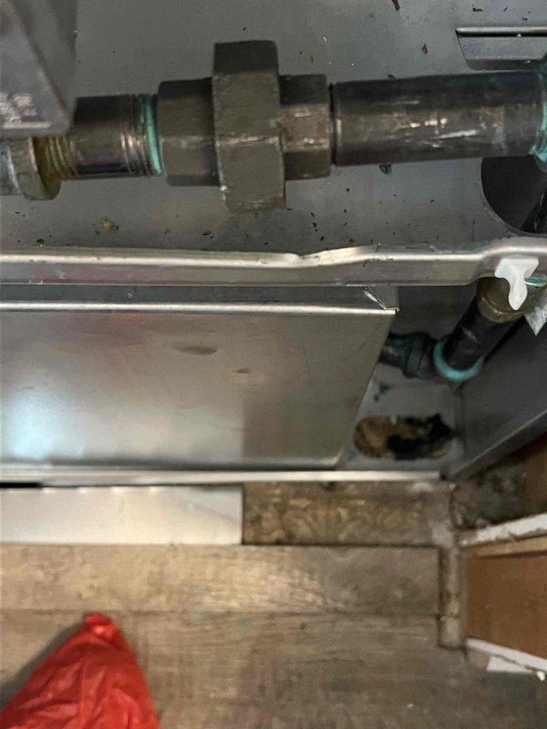 Completed comprehensive tune-up and inspection on Bryant brand air conditioning system over 10 years old at mobile home residence. Outdoor condensing unit examined with focus on compressor operation, refrigerant levels, electrical connections, and condenser coil cleanliness. Verified proper function of condensate pump assembly mounted on exterior wall, checked drain line flow and pump operation. Indoor evaporator coil accessed in utility closet, inspected coil condition, refrigerant line connections including compression fittings and O-ring seals, and verified drain pan integrity. All components found operational, system running within normal parameters at time of inspection.