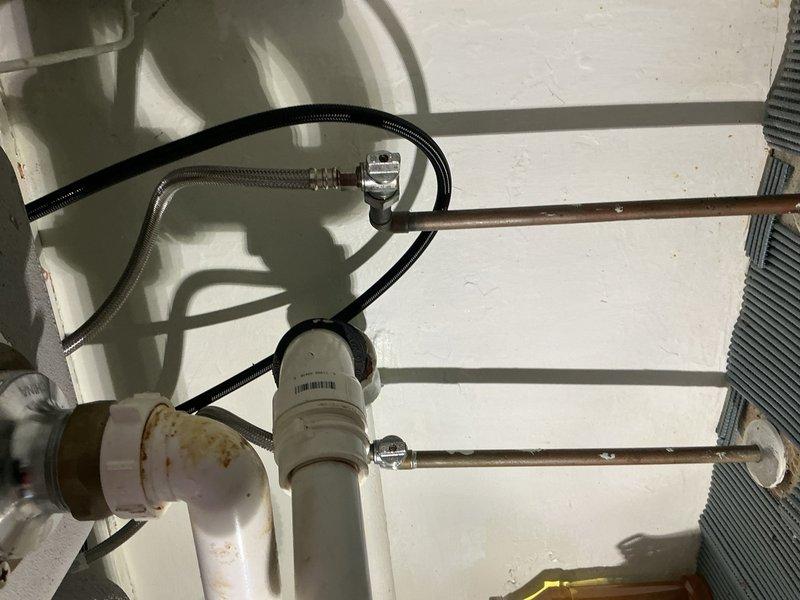 Completed installation of customer-provided kitchen faucet on stainless steel double-basin sink with granite countertop. Removed existing fixture, installed new polished chrome high-arc spout faucet with dual-handle deck-mount configuration, connected supply lines, and tested for proper operation and leak-free performance.