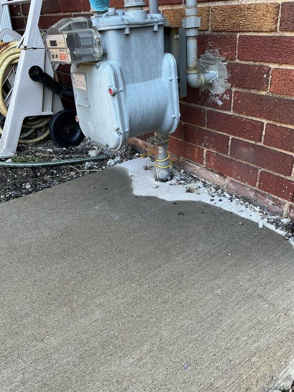 Responded to gas leak in basement previously identified by utility company. Upon arrival, found home under active renovation with exposed framing, debris, and construction materials throughout basement area. Performed thorough inspection of existing gas piping system of unknown age to locate source of leak. Evaluated all gas line connections, joints, and fittings in basement area where leak was reported. System remained operational during inspection. Documented conditions with photographs showing basement renovation status and exterior mechanical equipment including pump assembly mounted on foundation wall. Provided assessment of gas piping condition and leak location for necessary repairs to ensure safe operation of gas system.