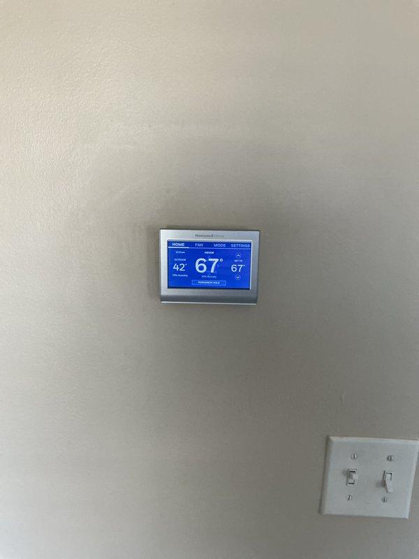 Completed HVAC system replacement estimate for central air conditioning unit with chronic refrigerant loss over multiple years. System assessment revealed non-functional cooling with airflow issues despite fan operation. Evaluated existing equipment including interior components, capacitor, refrigerant lines, and thermostat displaying current temperature readings, documenting condition for replacement recommendation and equipment buyback consideration.