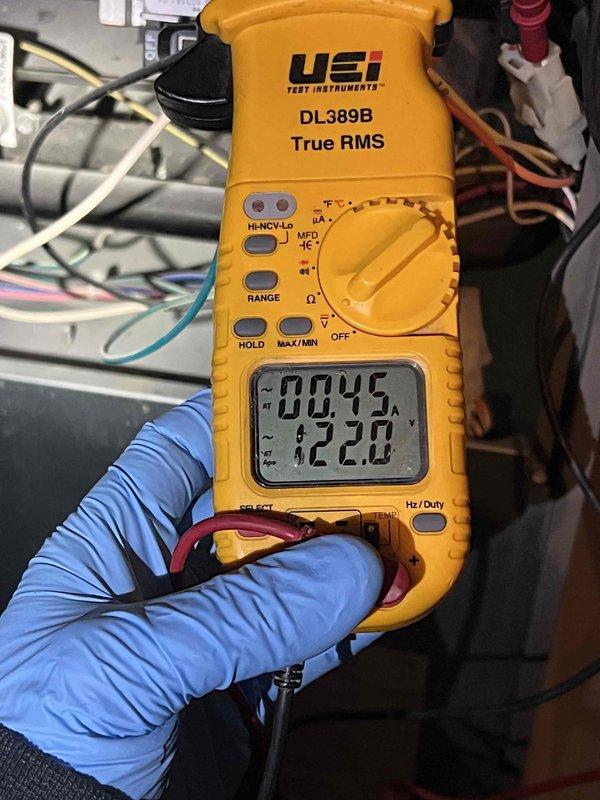 Responded to service call for furnace pilot issue on unit located in basement, less than 10 years old. Performed diagnostic testing using digital multimeter to measure voltage and electrical parameters at control board and gas valve assembly. Verified proper voltage readings of 122.8V and microamp readings of 00.45 on flame sensor circuit. Inspected pilot assembly, flame sensor, and ignition system components to ensure proper operation and safe functionality of heating system.