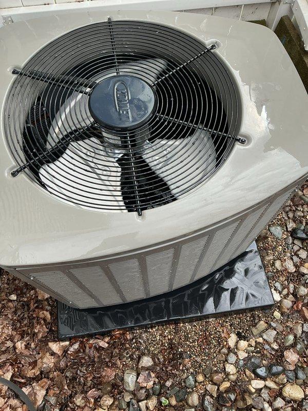 Completed comprehensive Gold AC inspection on 4-month-old residential air conditioning system with air handler located in basement. Performed thorough evaluation of outdoor condenser unit, which showed clean operational condition with intact components and proper fan assembly function. Inspected internal components through top-mounted grille, verified condenser coil cleanliness, and assessed overall system performance. Examined electrical connections, refrigerant lines, and condensate drainage system. Noted unit is properly positioned on protective pad with adequate clearance from structure. Advised customer that surrounding area requires maintenance to remove accumulated leaves, debris, and organic matter to ensure optimal airflow and prevent potential system efficiency issues. Verified all safety controls, tested capacitor readings, and confirmed proper amperage draw on compressor and fan motor. System operating within manufacturer specifications with no immediate service needs ident