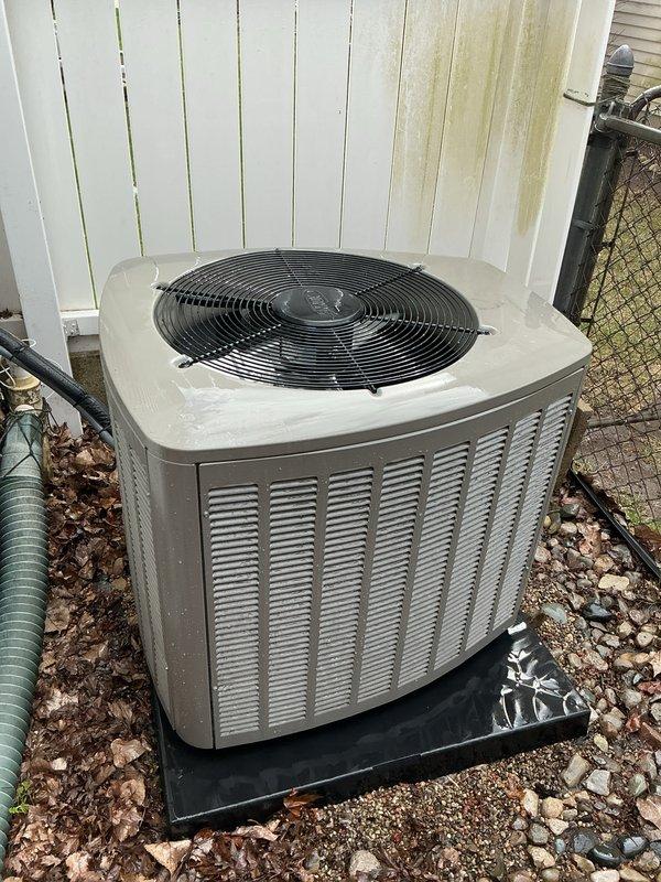 Completed comprehensive Gold AC inspection on 4-month-old residential air conditioning system with air handler located in basement. Performed thorough evaluation of outdoor condenser unit, which showed clean operational condition with intact components and proper fan assembly function. Inspected internal components through top-mounted grille, verified condenser coil cleanliness, and assessed overall system performance. Examined electrical connections, refrigerant lines, and condensate drainage system. Noted unit is properly positioned on protective pad with adequate clearance from structure. Advised customer that surrounding area requires maintenance to remove accumulated leaves, debris, and organic matter to ensure optimal airflow and prevent potential system efficiency issues. Verified all safety controls, tested capacitor readings, and confirmed proper amperage draw on compressor and fan motor. System operating within manufacturer specifications with no immediate service needs ident