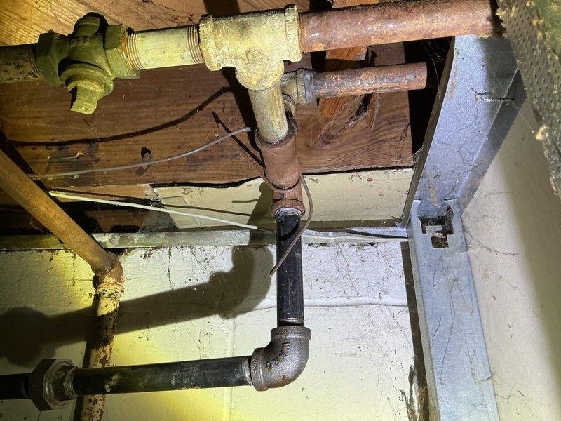 Responded to gas shutoff by utility company due to multiple gas leaks detected in basement. Performed comprehensive pressure test on gas piping system to identify all leak locations throughout the aged gas distribution network, which included corroded copper piping, yellow-painted gas lines, and various threaded fittings showing significant wear and oxidation. Documented leak locations and provided estimate for necessary repairs to restore safe gas service to the residence.