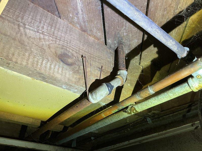 Responded to gas shutoff by utility company due to multiple gas leaks detected in basement. Performed comprehensive pressure test on gas piping system to identify all leak locations throughout the aged gas distribution network, which included corroded copper piping, yellow-painted gas lines, and various threaded fittings showing significant wear and oxidation. Documented leak locations and provided estimate for necessary repairs to restore safe gas service to the residence.