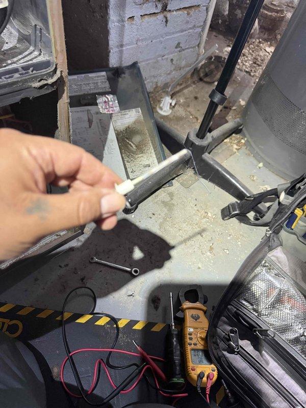 Responded to service call for furnace blowing cold air in basement location. Upon arrival, performed diagnostic evaluation on 10+ year old furnace unit, model MGF1L060AP12MP11A with 60,000 BTUH output capacity. Conducted electrical testing using multimeter to assess system functionality and component operation. Inspected unit which showed significant dust and debris accumulation on equipment surfaces and internal components. Completed thorough system assessment and identified root cause of heating failure.