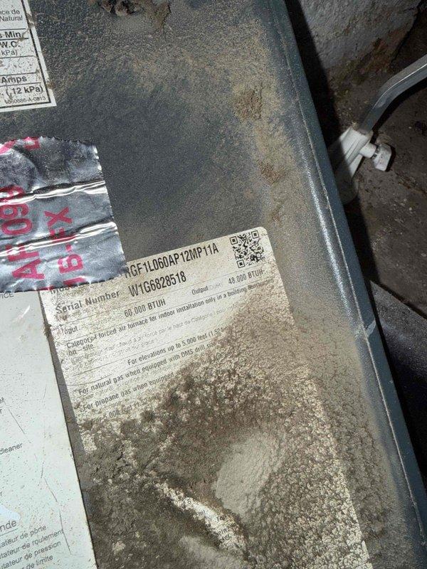 Responded to service call for furnace blowing cold air in basement location. Upon arrival, performed diagnostic evaluation on 10+ year old furnace unit, model MGF1L060AP12MP11A with 60,000 BTUH output capacity. Conducted electrical testing using multimeter to assess system functionality and component operation. Inspected unit which showed significant dust and debris accumulation on equipment surfaces and internal components. Completed thorough system assessment and identified root cause of heating failure.