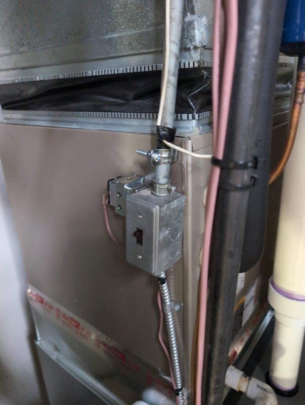Completed electrical warranty inspection addressing multiple NEC code compliance items on new furnace installation. Properly secured 1/2 inch EMT conduit and MC cable to furnace cabinet per support requirements outlined in NEC 358.30(2) and 330.30. Verified equipment grounding conductor termination inside furnace unit and demonstrated proper landing to electrical inspector per NEC 250.148(C). Addressed inspector concerns regarding internal transformer connection tapping from furnace 120V circuit and secured transformer mounting to prevent loose placement inside unit cabinet per NEC 90.4 requirements. Corrected panel schedule labeling discrepancy where unit was marked as "#2" at equipment but panel legend only indicated "furnace" to ensure proper circuit identification per NEC 110.21(A). Installed missing faceplate screw on handy box mounted to furnace side to restore proper equipment installation standards per NEC 110.3(B). All corrections documented with photographic evidence showing 