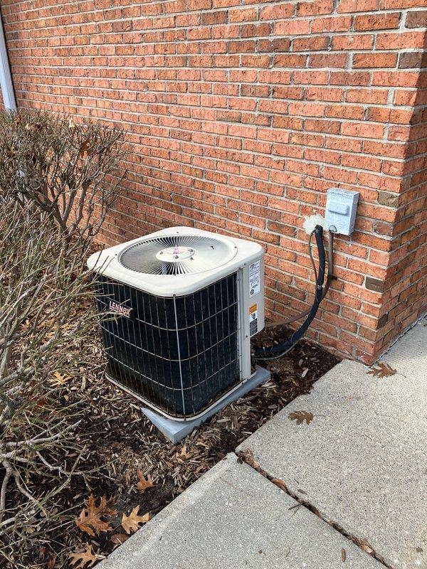 Conducted comprehensive on-site evaluation for full HVAC system replacement at residential property. Assessed existing Lennox outdoor condensing unit positioned on concrete pad against brick exterior, noting electrical disconnect box and conduit configuration. Inspected indoor air handler unit measuring 17.25" x 14.25" installed in utility area with existing refrigerant line set and condensate drain system. Documented current equipment specifications, installation conditions, and clearance requirements. Photographed both outdoor and indoor components to support detailed replacement proposal. Provided customer with complete system replacement options and recommendations based on existing infrastructure and equipment configuration.