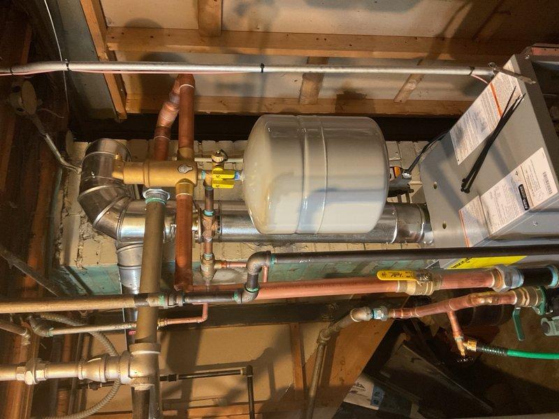 Completed full boiler installation in residential basement utility area. Installed new boiler system with associated expansion tank, copper piping network, gas lines, and all necessary connections and fittings. Permit was requested and financing documentation was completed and signed with identification verified on file.