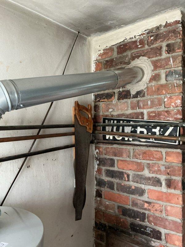 Returned to address plumbing inspection violation on water heater installation where the vent pipe had been improperly reduced from 4-inch to 3-inch diameter. Corrected the venting configuration to maintain proper 4-inch diameter throughout the vent run as required by code, ensuring adequate draft and combustion gas exhaust. Documented the completed correction with photographs for inspector approval as requested.