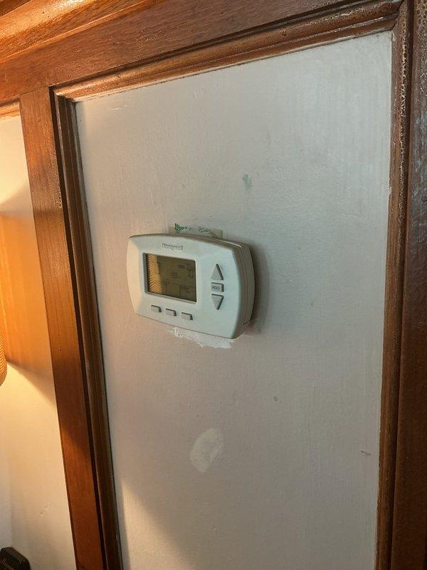 Responded to service call for boiler experiencing persistent low water level issues despite having an operational automatic feeder. Upon arrival, verified heating system remained functional. Conducted thorough inspection of boiler water level controls, feed system components, and associated valves. Examined red gate valve on brass piping, water level indicators, and automatic feeder mechanism for proper operation. Documented current system conditions with photographic evidence showing thermostat operation and boiler equipment configuration. Identified potential issues with automatic water feeder requiring further monitoring or component replacement to maintain proper water levels and prevent future system complications.