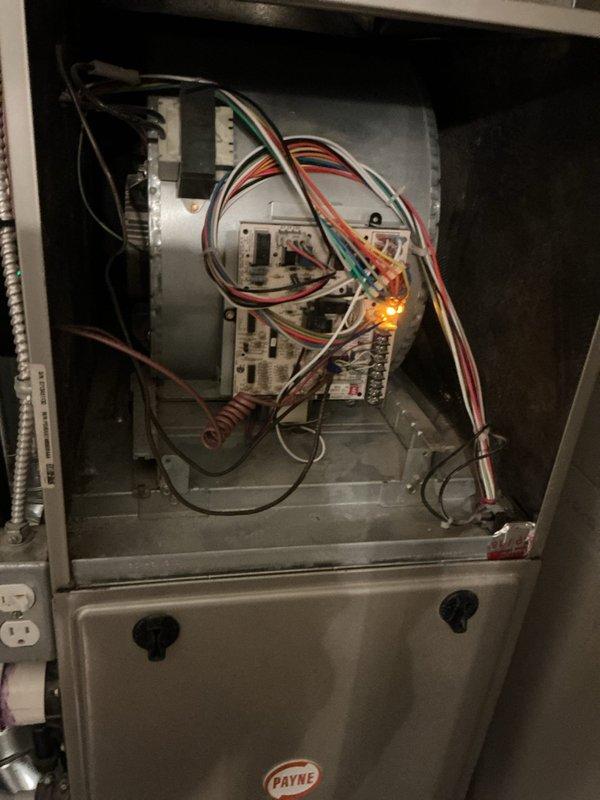 Responded to service call for 10-year-old Payne furnace system with half of residence receiving cold air while other zones functioned properly. Accessed unit in utility room, removed cabinet panel, and performed diagnostic inspection of control board, blower assembly, and zone damper system. Identified control board malfunction affecting zone valve operation, inspected all electrical connections and wiring harnesses, and verified proper LED indicator status on circuit board to isolate the issue causing uneven heating distribution throughout the home.