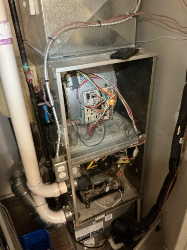 Responded to service call for 10-year-old Payne furnace system with half of residence receiving cold air while other zones functioned properly. Accessed unit in utility room, removed cabinet panel, and performed diagnostic inspection of control board, blower assembly, and zone damper system. Identified control board malfunction affecting zone valve operation, inspected all electrical connections and wiring harnesses, and verified proper LED indicator status on circuit board to isolate the issue causing uneven heating distribution throughout the home.