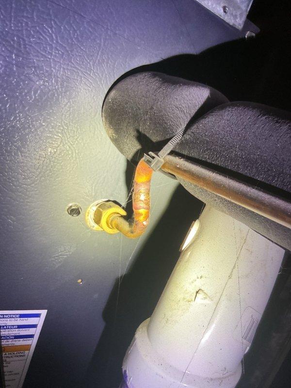 # AC Tune-Up Completed

Performed comprehensive annual maintenance inspection on 5-year-old air conditioning system located in backyard as part of prepaid maintenance membership. Conducted complete system evaluation including refrigerant level check, electrical component testing, and condenser coil inspection. Verified proper operation of compressor and fan motor. Inspected and documented humidifier filter pad condition, noting honeycomb mesh pattern intact with minimal debris accumulation. Examined plumbing connections associated with humidifier system, including copper piping and brass shut-off valve with proper accessibility. All components found operating within manufacturer specifications. System performing efficiently with no immediate service needs identified. Unit cleared for continued operation through next scheduled maintenance interval in 2026.