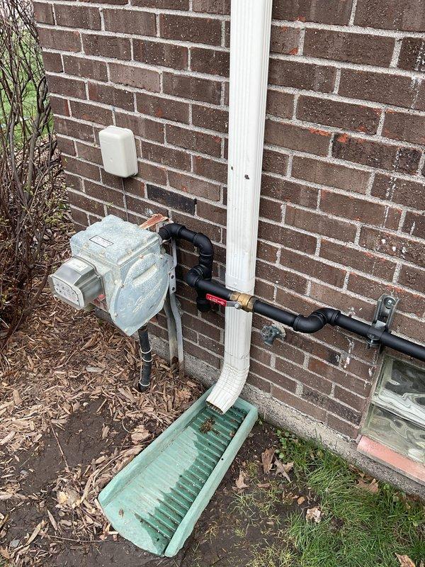 Completed installation of 18kW standby generator system including all mechanical, electrical, and gas piping components. Installed automatic transfer switch in basement utility area with proper circuit breaker integration to existing electrical panel. Ran black gas piping along exterior brick wall from natural gas meter to generator location, performed pressure testing to verify system integrity, and coordinated permit requirements for the complete installation.