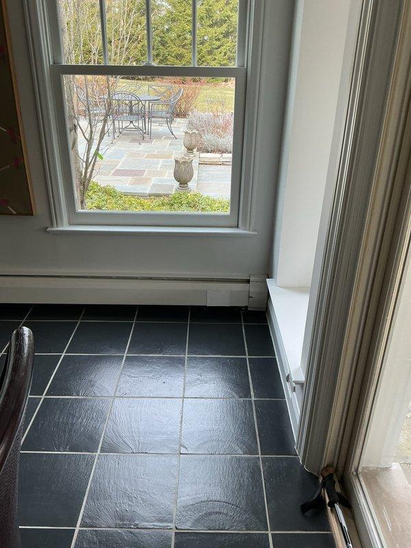 Responded to service call for water leak from hot water baseboard heating fins in dining room area. Performed diagnostic inspection of 2-year-old water boiler system and associated baseboard heating components. Identified source of leak at baseboard fin connections and assessed system for proper operation and additional concerns.