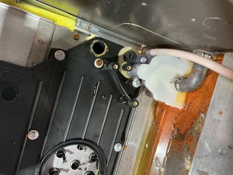 Responded to diagnostic error code displayed on thermostat for 1-year-old Carrier furnace with manufacturer-issued safety notification. Upon inspection, identified significant discoloration and staining on condensate drain components and housing, indicating potential drainage system issues that may have triggered safety alerts. Examined blower assembly, heat exchanger access points, and associated mechanical connections for signs of moisture intrusion or combustion concerns. Verified furnace operational status and documented condition of air filtration system. Photographed affected components showing yellow and brown staining on plastic drain fittings and rust-colored corrosion on surrounding surfaces for warranty documentation purposes.