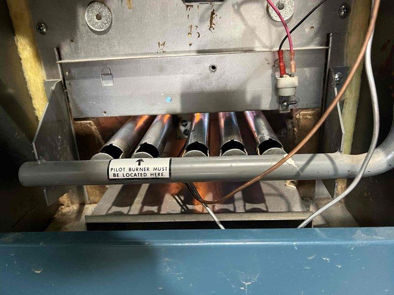 Completed comprehensive tune-up and maintenance service on basement-located heating system including boiler, tanked water heater, and Navien tankless water heater, all over 10 years old. Performed full system inspection, flushed tankless unit to remove mineral buildup and ensure optimal performance, and verified proper operation of burner assembly and pilot components. All equipment tested and confirmed operational upon service completion.