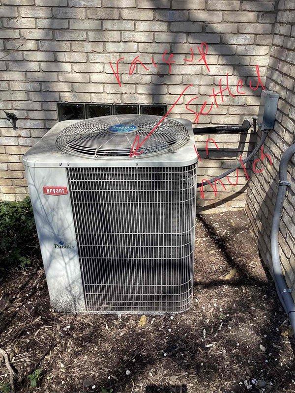 Performed comprehensive diagnostic evaluation on 20-year-old Bryant air conditioning system located in backyard. Identified low refrigerant charge and weak capacitor during routine tune-up inspection. System currently operational but exhibiting performance deficiencies due to age and component degradation. Documented equipment condition with photographic evidence showing outdoor condenser unit positioned against brick exterior wall with electrical disconnect properly installed. Provided replacement estimate due to advanced age of equipment and identified deficiencies requiring attention for continued reliable operation.