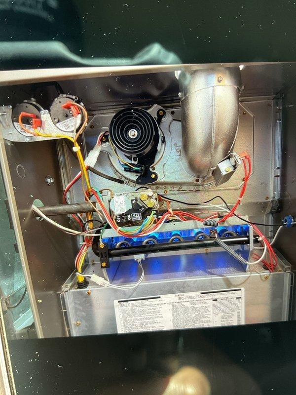 Responded to a no-heat call where the gas furnace in the basement was running but blowing room temperature air only. Upon inspection with the access panel removed, performed electrical diagnostics using a clamp meter which revealed a 0.14 amp draw, indicating the induced draft blower motor was operating but the burners were not igniting. Troubleshot the ignition sequence and gas valve assembly, checking pressure switches, flame sensor, and control board connections to identify the failure point preventing proper burner operation and heat production.