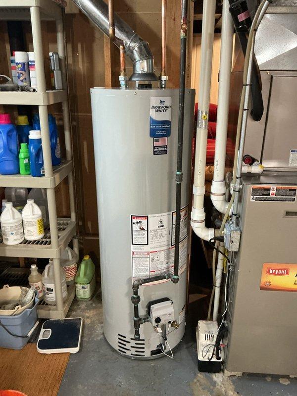 Responded to a no-heat condition and active water leak from an existing water heater affecting the entire residence. Removed and disposed of the failed unit located in the basement utility area. Installed a new 40-gallon Bradford White standard residential water heater, reconnecting all existing copper supply lines, gas piping with shut-off valve, and metallic vent system. Verified proper venting configuration, tested all connections for leaks, confirmed gas valve operation, and restored hot water service to the home.