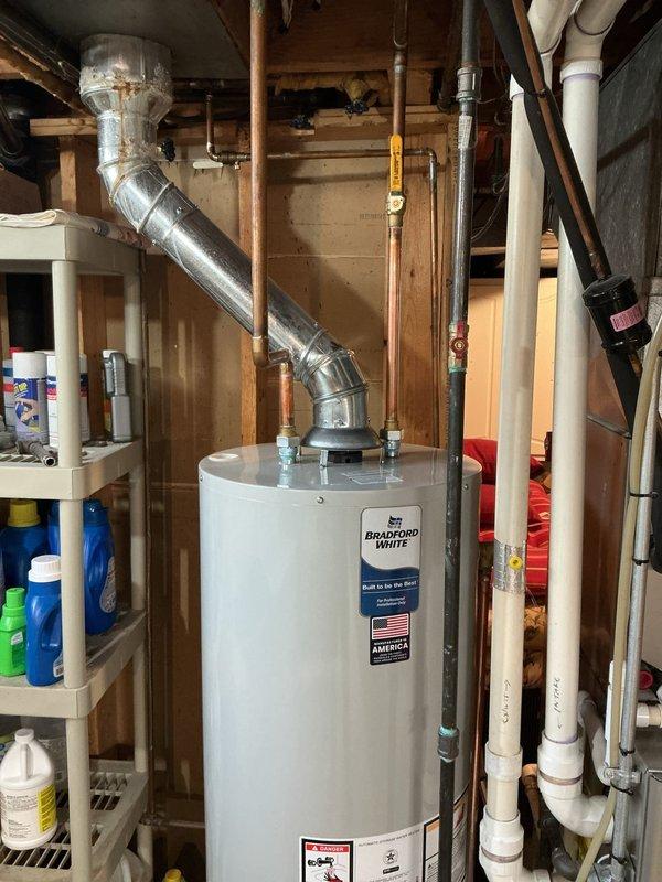 Responded to a no-heat condition and active water leak from an existing water heater affecting the entire residence. Removed and disposed of the failed unit located in the basement utility area. Installed a new 40-gallon Bradford White standard residential water heater, reconnecting all existing copper supply lines, gas piping with shut-off valve, and metallic vent system. Verified proper venting configuration, tested all connections for leaks, confirmed gas valve operation, and restored hot water service to the home.