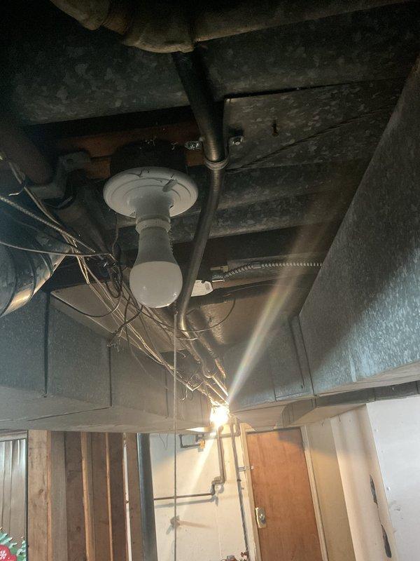 Provided estimate for installation of new half-inch TRAC gas line to supply kitchen stove. Assessed existing basement utility area infrastructure, including current gas piping configuration, ceiling-mounted fixtures, and available routing paths through exposed joists. Documentation photos captured existing conditions of utility space, including ceiling structure, exposed piping, and access points for proposed gas line installation.