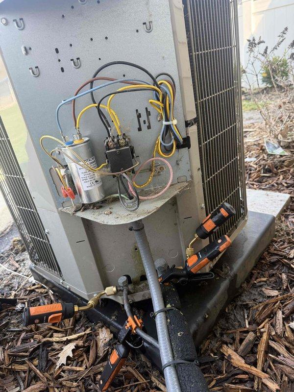 Completed comprehensive tune-up and maintenance service on 12-year-old Bryant AC and furnace system. Performed detailed inspection of outdoor condensing unit with access panel removal, verified electrical connections including capacitor and contactor functionality, tested refrigerant pressures using manifold gauges to ensure proper system charge, and inspected copper refrigerant lines for integrity. All components found operating within normal parameters, system tested and confirmed working properly upon completion.