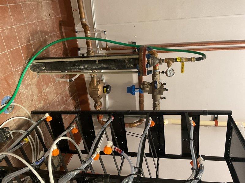 Provided estimate for installation of water supply piping from interior plumbing system to exterior location for sprinkler system connection. Assessed existing mechanical room manifold assembly and identified appropriate tie-in point at copper distribution system. Evaluated exterior routing path through foundation or wall penetration to designated outdoor termination point where third-party irrigation contractor will complete sprinkler system hookup.