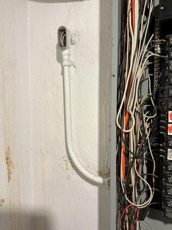 Responded to service call for electrical panel experiencing water intrusion and corrosion in basement area. Upon inspection, found extensive rust and deterioration on lower portion of panel enclosure due to moisture exposure during rain events. Panel base showed significant corrosion, pitting, and accumulated debris with rust staining across metal surfaces. Circuit breakers in upper section remained functional but panel integrity was compromised by water damage at bottom where conduits enter. Documented existing conditions with photographs showing corroded panel base, deteriorated metal components, and moisture-related damage to enclosure while breakers remained operational above affected area.