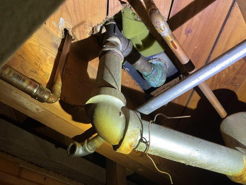 Responded to bathtub drain leak causing water to drip onto basement floor. Accessed plumbing system through basement ceiling to locate source of leak at drain pipe connection. Upon inspection, identified deteriorated pipe joint and loose fitting at the tub drain assembly where water was escaping during drainage. Disassembled affected section, cleaned connection points, and reinstalled drain piping with proper sealing. Replaced worn gaskets and tightened all compression fittings at the manifold junction. Tested system by running water through the tub drain while monitoring for leaks from basement below. Verified complete repair with no further water discharge to basement floor.