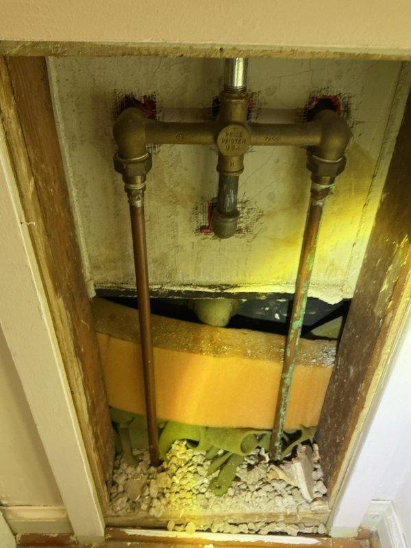 Responded to bathtub drain leak causing water to drip onto basement floor. Accessed plumbing system through basement ceiling to locate source of leak at drain pipe connection. Upon inspection, identified deteriorated pipe joint and loose fitting at the tub drain assembly where water was escaping during drainage. Disassembled affected section, cleaned connection points, and reinstalled drain piping with proper sealing. Replaced worn gaskets and tightened all compression fittings at the manifold junction. Tested system by running water through the tub drain while monitoring for leaks from basement below. Verified complete repair with no further water discharge to basement floor.