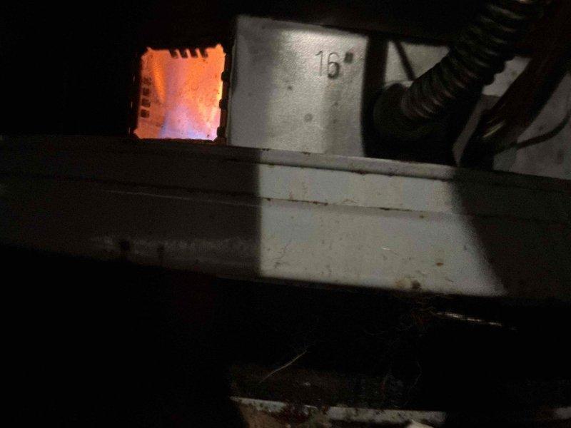 Responded to a no hot water complaint affecting the property for two weeks. Upon inspection, discovered a failed gas valve assembly with significant corrosion on electrical connections and mounting hardware. The gas valve showed evidence of moisture exposure leading to terminal degradation. Verified furnace ignition system was operational with visible flame present in combustion chamber. Documented corroded wiring and compromised valve components for replacement recommendation.