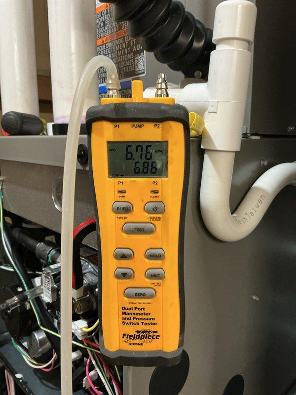 Completed full HVAC system installation including 70,000 BTU furnace, 3-ton rear-discharge air conditioning unit with AHRI certification #215664802, humidifier, and liner. Installed 40-gallon hot water heater with pump and reconnected all necessary utilities. Performed pressure switch testing using diagnostic equipment, confirming proper system operation with readings of 6.76 and 6.86 inWC. Installed exterior PVC condensate drainage lines through brick exterior wall with proper termination and grading. Obtained mechanical and electrical permits for all installed equipment, and system qualifies for applicable utility rebates.