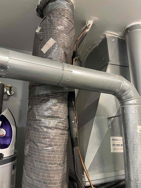 Completed comprehensive HVAC system estimate for full equipment replacement in residential utility space. Assessed existing installation including air handler unit, ductwork configuration with flexible and rigid metallic components, refrigerant line routing, and integration with water heating equipment. Documented current system layout, duct transitions, elbow connections, and mechanical room infrastructure to provide accurate replacement specifications and installation requirements.