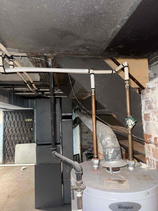 Responded to service call for furnace diagnostic and water heater inspection. Upon arrival, accessed basement mechanical room and performed comprehensive visual inspection of both units. Examined furnace cabinet, verified proper clearances, and inspected visible components including blower assembly, control board access, and gas connections. Assessed overall condition of heating system and documented equipment age and operational status. Conducted thorough inspection of Whirlpool water heater, examining temperature and pressure relief valve, gas control valve, pilot assembly, and all visible piping connections including copper supply lines and venting system. Verified proper installation of safety components and checked for signs of corrosion, leaks, or deterioration. Photographed both units and mechanical room configuration for documentation purposes. Provided assessment findings and recommendations to customer regarding repair versus replacement options for furnace system based on eq