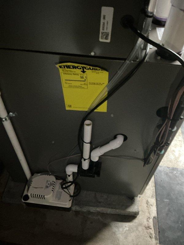 Responded to service call for missing condensation pump from humidifier system. Upon inspection of basement-located HVAC air handler unit, confirmed that condensate pump assembly was not present at equipment. Documented existing installation showing air handler with standard condensate drain piping configuration using white PVC with proper joints and elbows, but lacking dedicated humidifier condensate pump component. Photographed current system setup including visible drainage lines, electrical connections, and equipment placement for warranty documentation purposes.