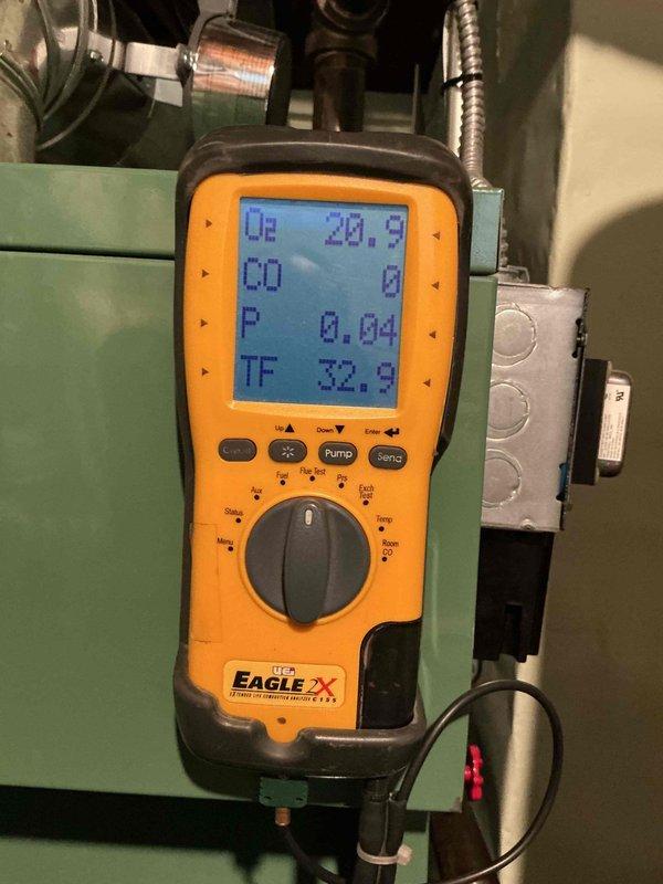 Completed comprehensive boiler inspection at basement location. Performed combustion analysis using digital diagnostic meter, recording oxygen levels at 20.8%, carbon monoxide at 0 ppm, pressure at 0.04, and flue temperature at 32.9°F. Inspected internal heat exchanger components, evaporator coils, and electrical connections including capacitor and wiring harness; all components found to be in operational condition with no immediate safety concerns identified.