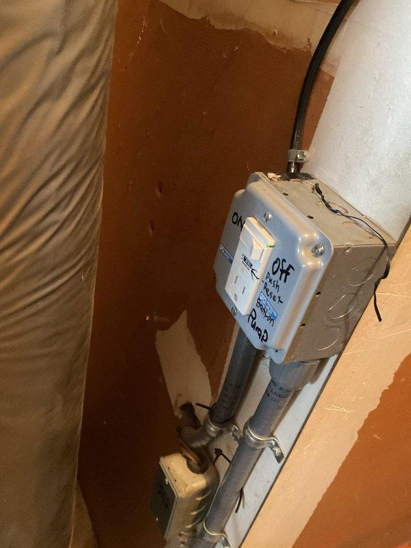 Responded to service call for water leaking from underneath 13+ year old furnace located in garage. Upon inspection, found condensate pump system previously addressed but issue persisting. Evaluated condensate drainage system including PVC piping, pump control box, and discharge lines. Documented existing pump installation and electrical connections for further assessment. Advised that despite previous repair attempt, condensate removal system requires additional troubleshooting to resolve ongoing water leak issue.