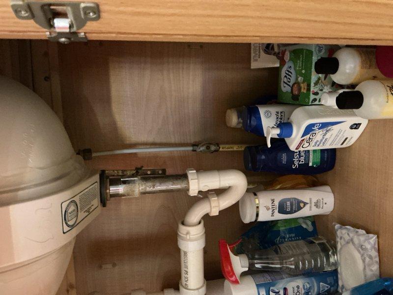 Responded to service call for leaking bathtub faucet. Upon arrival, conducted diagnostic inspection of bathroom plumbing system. Accessed under-sink plumbing through vanity cabinet to assess water supply lines and shut-off valves. Inspected visible PVC drain assembly, chrome P-trap, and braided metal flex supply lines for signs of moisture or deterioration. Examined main water supply valve assembly in mechanical room, including brass valve components, pressure relief valve, and associated copper and PEX piping connections. Documented existing plumbing configuration with photographs for service records. Identified source of leak and completed necessary repairs to restore proper function and eliminate water loss.