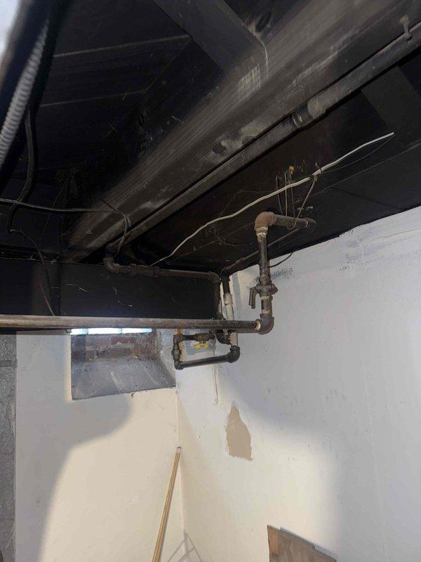 Responded to gas leak report on 13-year-old furnace located in basement. Upon arrival, contacted customer as requested prior to beginning inspection. Conducted thorough visual inspection of gas supply lines, connections, and furnace components in basement utility area. Inspected exposed copper gas piping, shut-off valves, and connection points along ceiling joists and vertical drops for signs of leakage or deterioration. Examined flexible gas connector at furnace and all threaded connections. Performed pressure test on gas line system to identify source and severity of leak. Documented existing plumbing infrastructure including pipe routing, valve locations, and overall condition of gas delivery system. Photographed gas line configuration, pipe supports, and connection points for estimate preparation. Noted unit continues to operate and provide heat despite reported leak. Provided customer with detailed assessment of gas line condition and prepared comprehensive estimate for necessary 