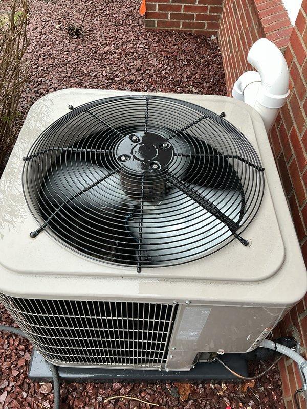 Completed comprehensive Gold-level furnace inspection on residential forced-air heating system located in basement. Unit is less than 10 years old and operational at time of service. Performed thorough visual examination of burner assembly, confirming proper ignition sequence with uniform blue flame pattern across all five burner ports indicating optimal air-to-fuel mixture and complete combustion. Inspected internal components including electrical connections, wiring harness, motor assemblies, and mounting hardware—all found to be secure and in good working condition. Examined exterior condensing unit positioned on concrete pad against structure, verified fan operation and protective grille integrity, checked refrigerant line connections and condensate drainage system. Documented equipment condition with photographs showing active burner flames, internal component layout, and exterior unit installation. All systems functioning within normal operating parameters with no immediate safet